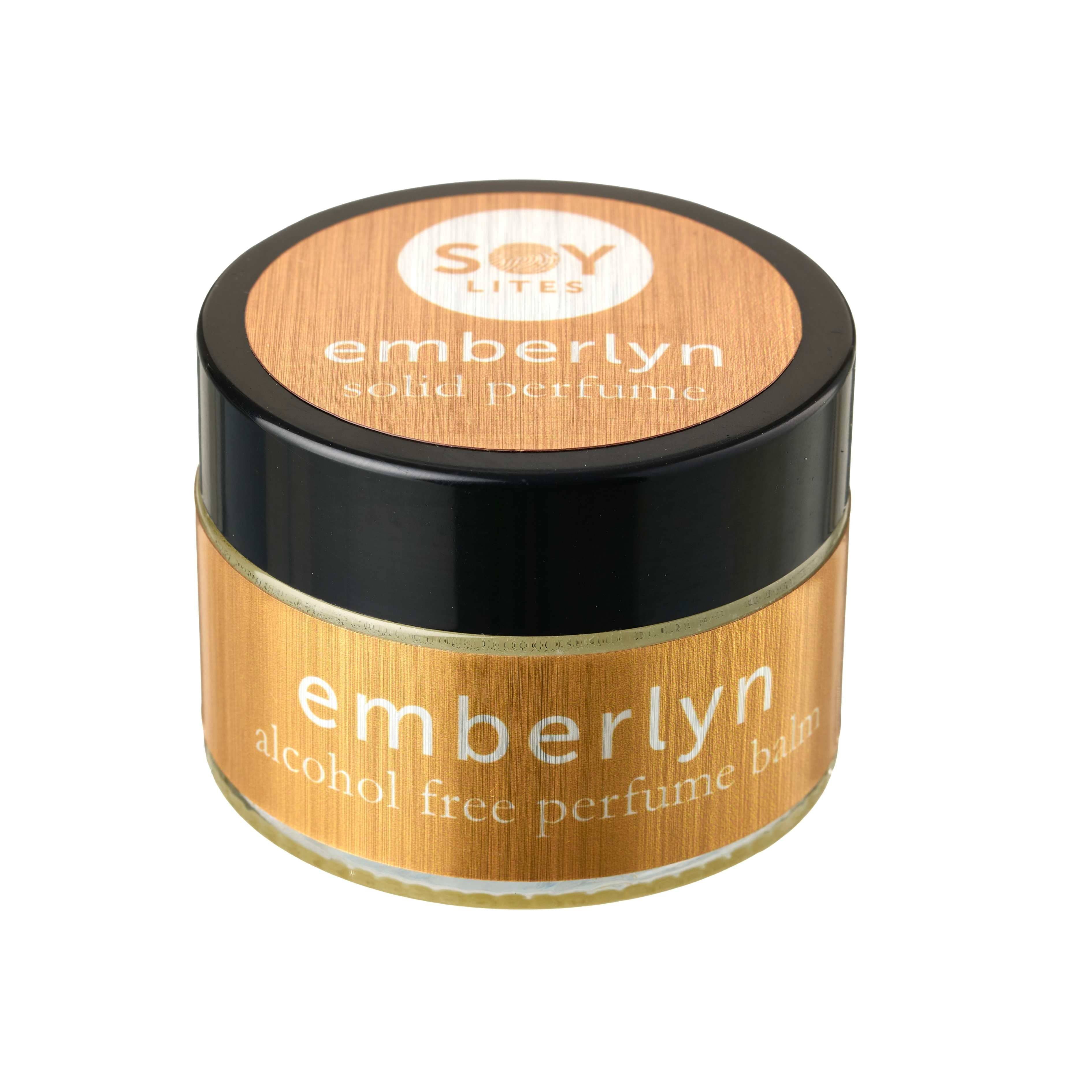 Wooden container of emberlyn solid perfume with black lid on a white background